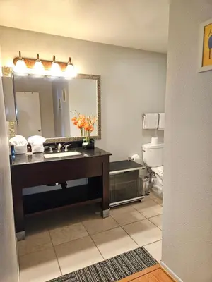 a bathroom with a sink and a mirror at Fullerton Inn in Fullerton