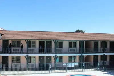 a building with people standing on the balcony at Best Whittier Inn in Whittier