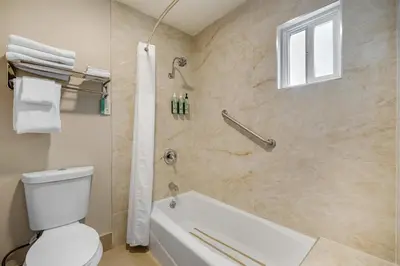 a bathroom with a white tub and a toilet at Best Western La Posada Motel in Fillmore