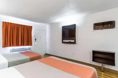 a hotel room with two beds and a flat screen tv at Motel 6-Long Beach, CA - International City in Long Beach