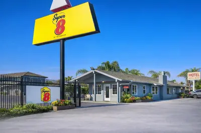 a sign for a fast food restaurant in front of a building at Super 8 by Wyndham Bakersfield CA in Bakersfield