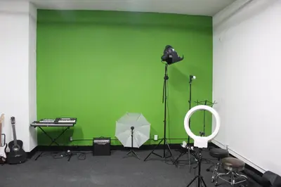 a green room with a microphone and an umbrella at Artist Housing - Downtown in Los Angeles