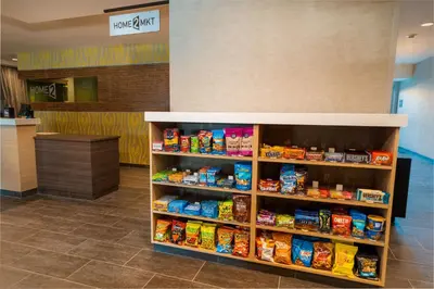 a food section of a store with a shelf of food at Home2 Suites Bakersfield in Bakersfield