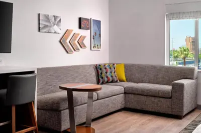 a living room with a couch and a table at Element Anaheim Resort Convention Center in Anaheim