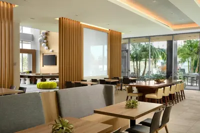 a restaurant with wooden tables and chairs and windows at Element Anaheim Resort Convention Center in Anaheim