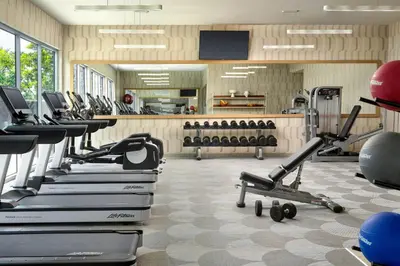 a gym with rows of treadmills and exercise bikes at Element Anaheim Resort Convention Center in Anaheim