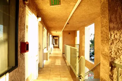 an empty hallway of a building with a hallway at Travelodge by Wyndham Pasadena Central in Pasadena