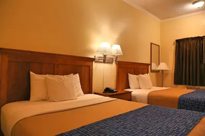 a hotel room with two beds in a room at Travelodge by Wyndham Pasadena Central in Pasadena