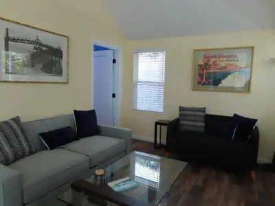 a living room with a couch and a table at Hill Street Cottage in Los Angeles