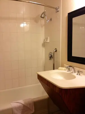 a bathroom with a sink and a tub and a mirror at Mikado Hotel in North Hollywood
