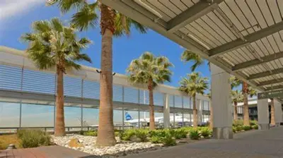 a row of palm trees in front of a building at Motel 6-Gardena, CA - South in Gardena