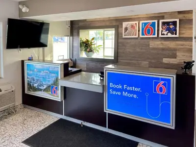 a book faster save more sign in a store at Motel 6-Delano, CA in Delano