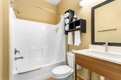 a bathroom with a white toilet and a sink at Best Western California City Inn & Suites in California City