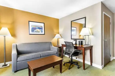a hotel room with a couch and a desk at Best Western California City Inn & Suites in California City