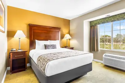a hotel room with a bed and a window at Best Western California City Inn & Suites in California City