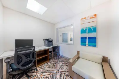 an office with a desk and a computer and a chair at Executive Residency by Best Western Victorville in Victorville