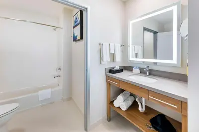 a white bathroom with a sink and a mirror at Executive Residency by Best Western Victorville in Victorville