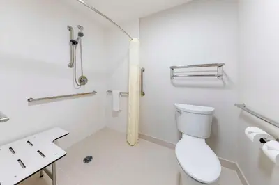 a white bathroom with a toilet and a sink at Executive Residency by Best Western Victorville in Victorville