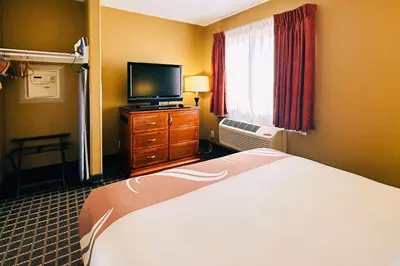 a hotel room with a bed and a flat screen tv at Quality Inn & Suites Westminster Seal Beach in Westminster