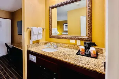 a bathroom with a sink and a mirror at Quality Inn & Suites Westminster Seal Beach in Westminster