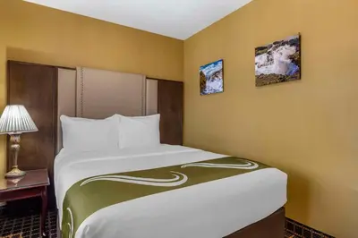 a bedroom with a large bed in a room at Quality Inn & Suites Westminster Seal Beach in Westminster