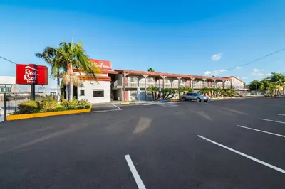 an empty parking lot in front of a hotel at Red Roof Inn Los Angeles - Bellflower in Bellflower