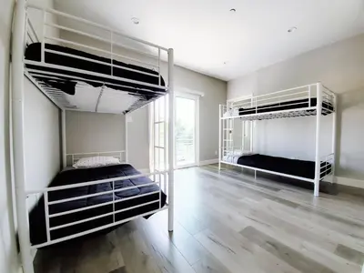 a bedroom with two bunk beds and a wooden floor at Modern Hostel address changed in Los Angeles