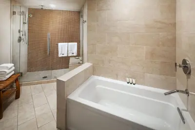 a bathroom with a large tub and a shower at The Westin Bonaventure Hotel & Suites, Los Angeles in Los Angeles