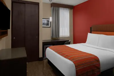 a hotel room with a bed and a television at SIRTAJ – Beverly Hills in Los Angeles