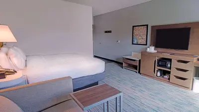 a hotel room with a bed and a flat screen tv at Hampton Inn Riverside Downtown in Riverside