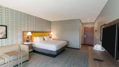 a hotel room with a bed and a couch at Hampton Inn Riverside Downtown in Riverside