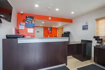 an office with a reception desk and orange wall at Motel 6-Ventura, CA - Downtown in Ventura