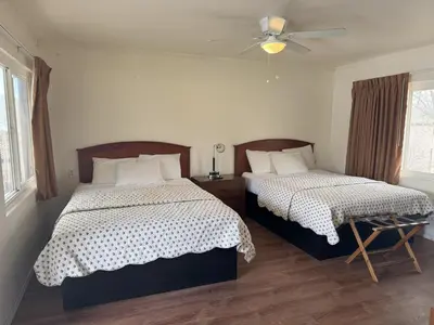 a bedroom with two beds and a ceiling fan at Lakeshore Lodge in Wofford Heights