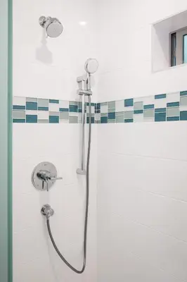 a shower in a bathroom with black and white tiles at Mid-Mod Retro Private Studio & Pool in Long Beach