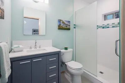 a bathroom with a toilet and a sink and a shower at Mid-Mod Retro Private Studio & Pool in Long Beach