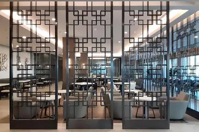 a restaurant with tables and chairs and a large chandelier at Courtyard by Marriott Los Angeles Monterey Park in Monterey Park