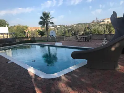 a swimming pool with a fountain in a yard at paradise luxury experience in Woodland Hills