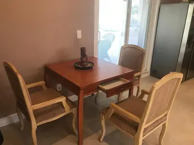 a wooden table and chairs with a bowl on top of it at paradise luxury experience in Woodland Hills