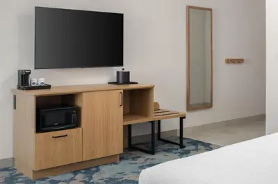 a television on a wooden stand in a room at Hampton Inn by Hilton North Hollywood in North Hollywood