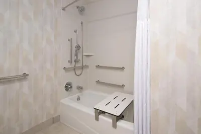 a bathroom with a bath tub with a sink at Hampton Inn by Hilton North Hollywood in North Hollywood
