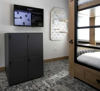 a bedroom with a bed and a tv on the wall at The Wayfarer Downtown LA, Tapestry Collection by Hilton in Los Angeles