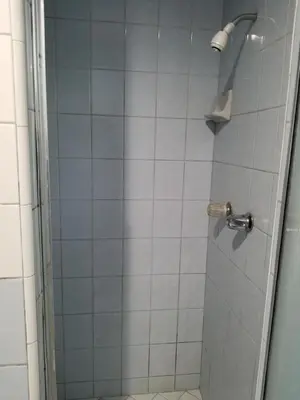 a bathroom with a shower with a glass door at Rose motel in Compton