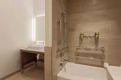 a bathroom with a shower with a tub and a sink at Element Ontario Rancho Cucamonga in Ontario