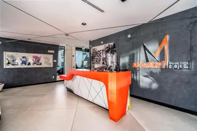 an exhibit at a museum with an orange counter at The Moment Hotel in Los Angeles