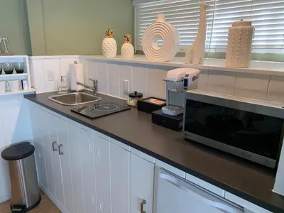 a kitchen counter with a sink and a microwave at Private Guest Suite in West Los Angeles in Los Angeles