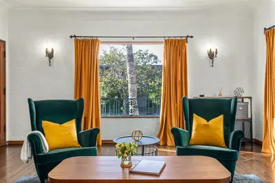 a living room with two chairs and a table and a window at Visit the Beach from a Historic Downtown Apartment - NRP21-00092 in Long Beach