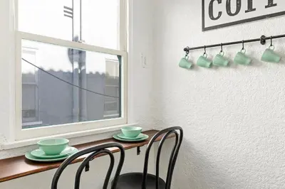 a dining room table with two chairs and a window at Visit the Beach from a Historic Downtown Apartment - NRP21-00092 in Long Beach