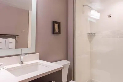 a white bathroom with a sink and a shower at TownePlace Suites by Marriott Thousand Oaks Agoura Hills in Agoura Hills