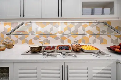 a kitchen with a counter with bowls of fruit at Hyatt Place Bakersfield in Bakersfield