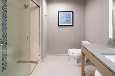 a bathroom with a toilet and a shower at Hyatt Place Bakersfield in Bakersfield